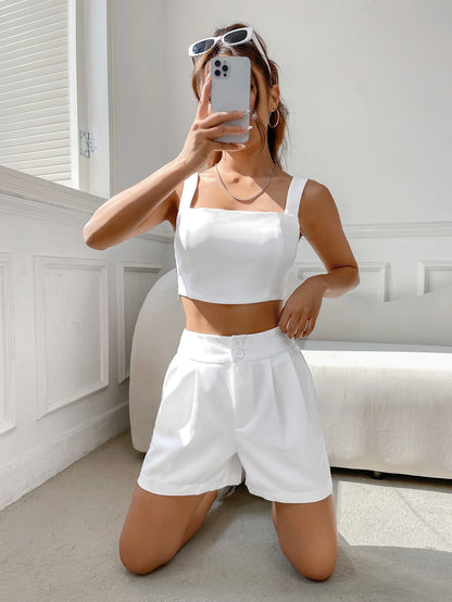 A casual suit for women with a one-neck halter top and white shorts