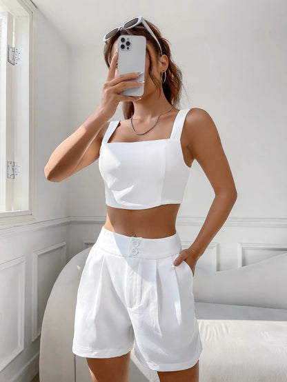 A casual suit for women with a one-neck halter top and white shorts